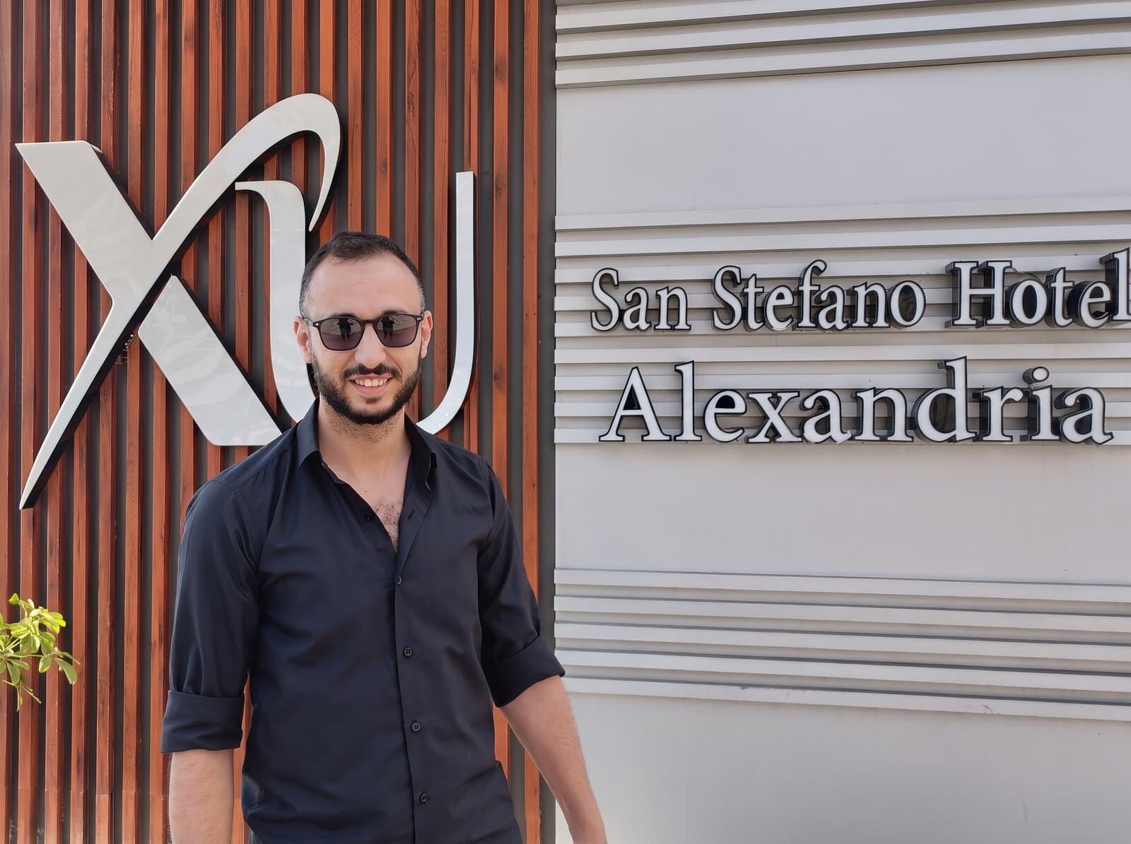 Khaled Fawzy Arafa (Khalid Arafa) standing outside the San Stefano Hotel Alexandria